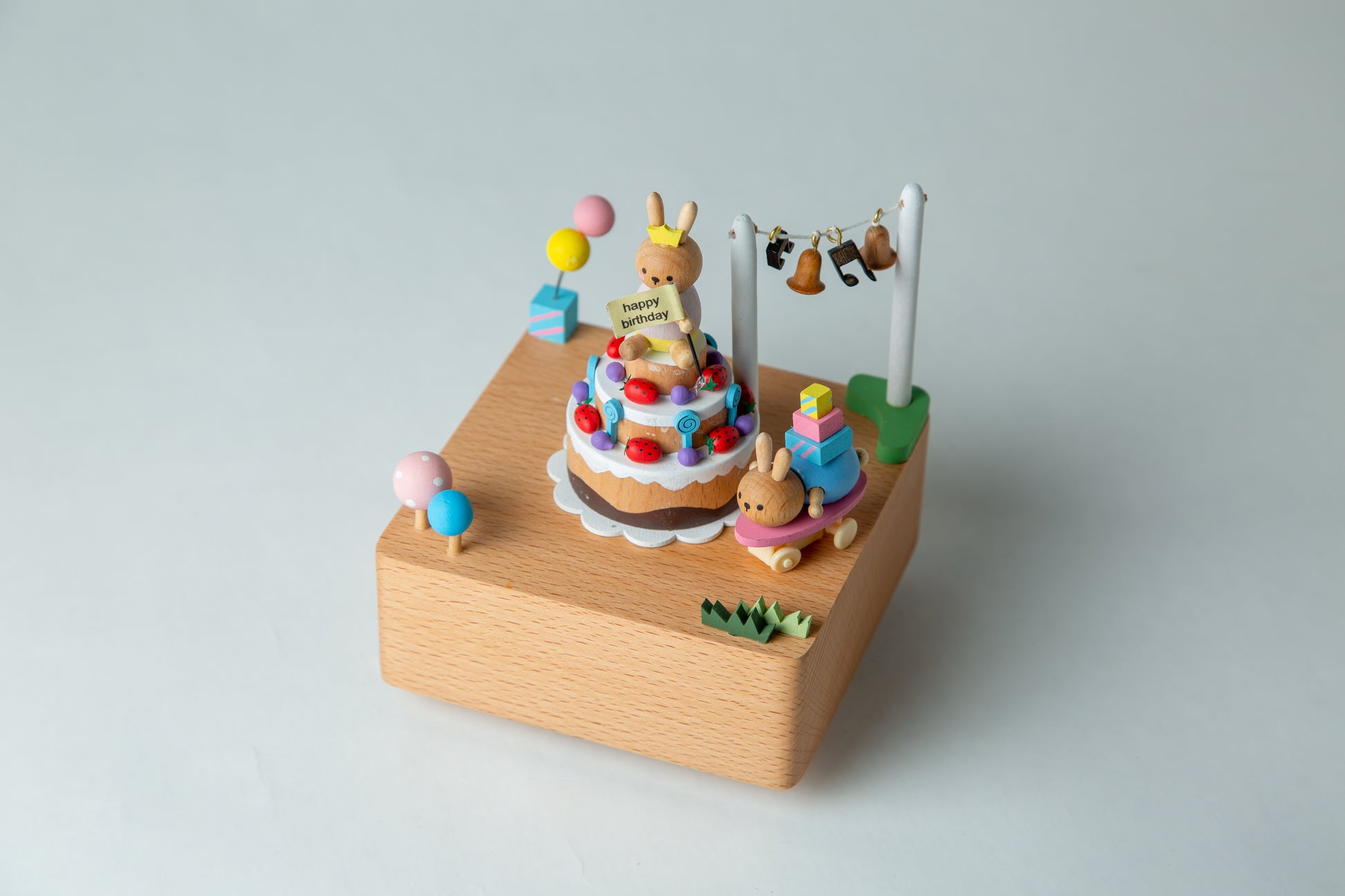 Small wooden toy set with colorful elements on a light gray background