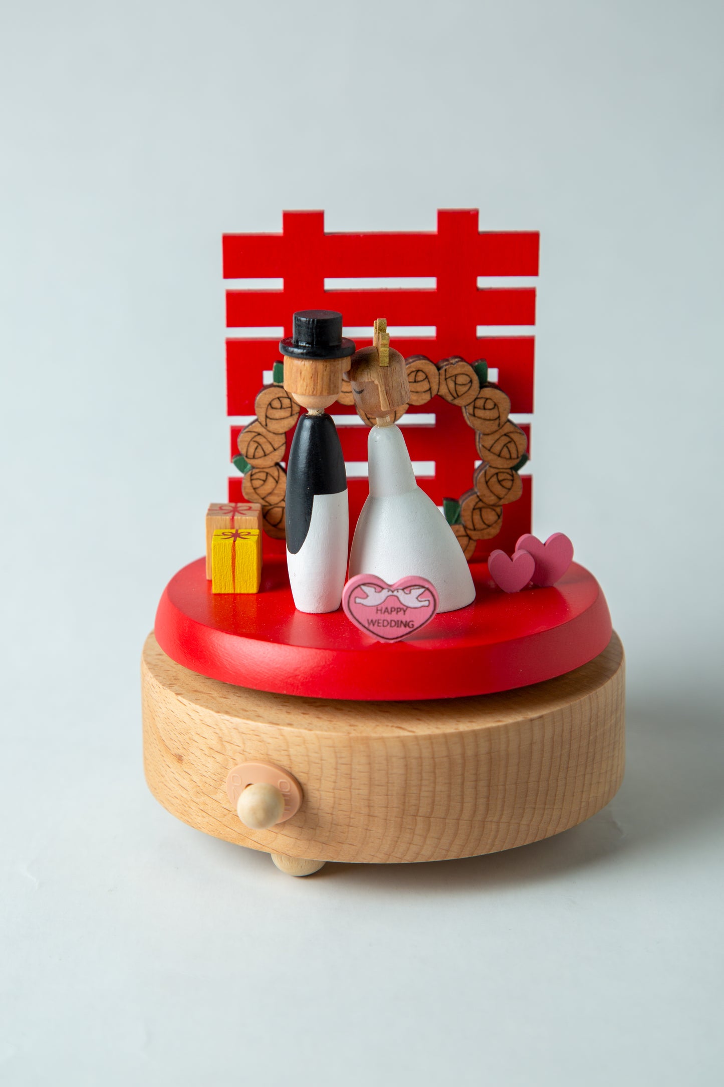 Decorative wooden figure with a red base and a red and white checkered background