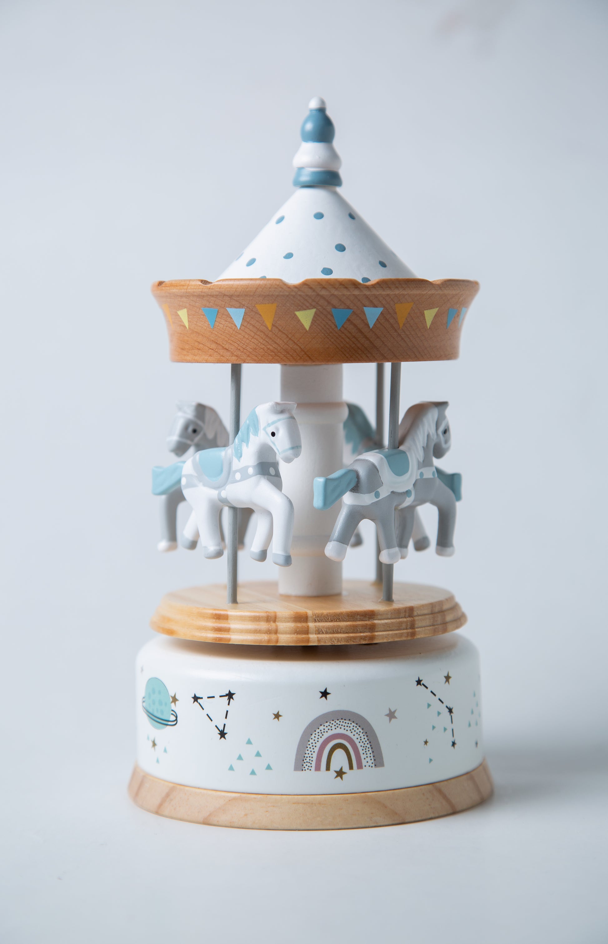 Decorative carousel with horses on a light gray background